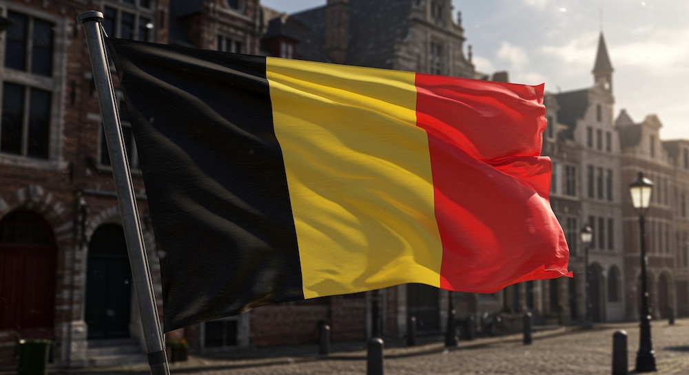 belgian flag waving in sunlight against urban backdrop