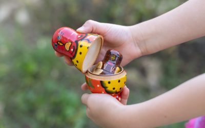 Сhild plays with matryoshka and opens it. nesting russian doll сhildren toy. matrioshka in kid's hands.